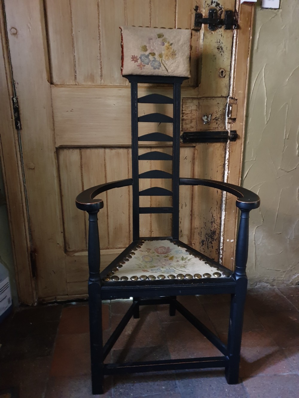 a very unusual tall arts and crafts ebonised tall armchair