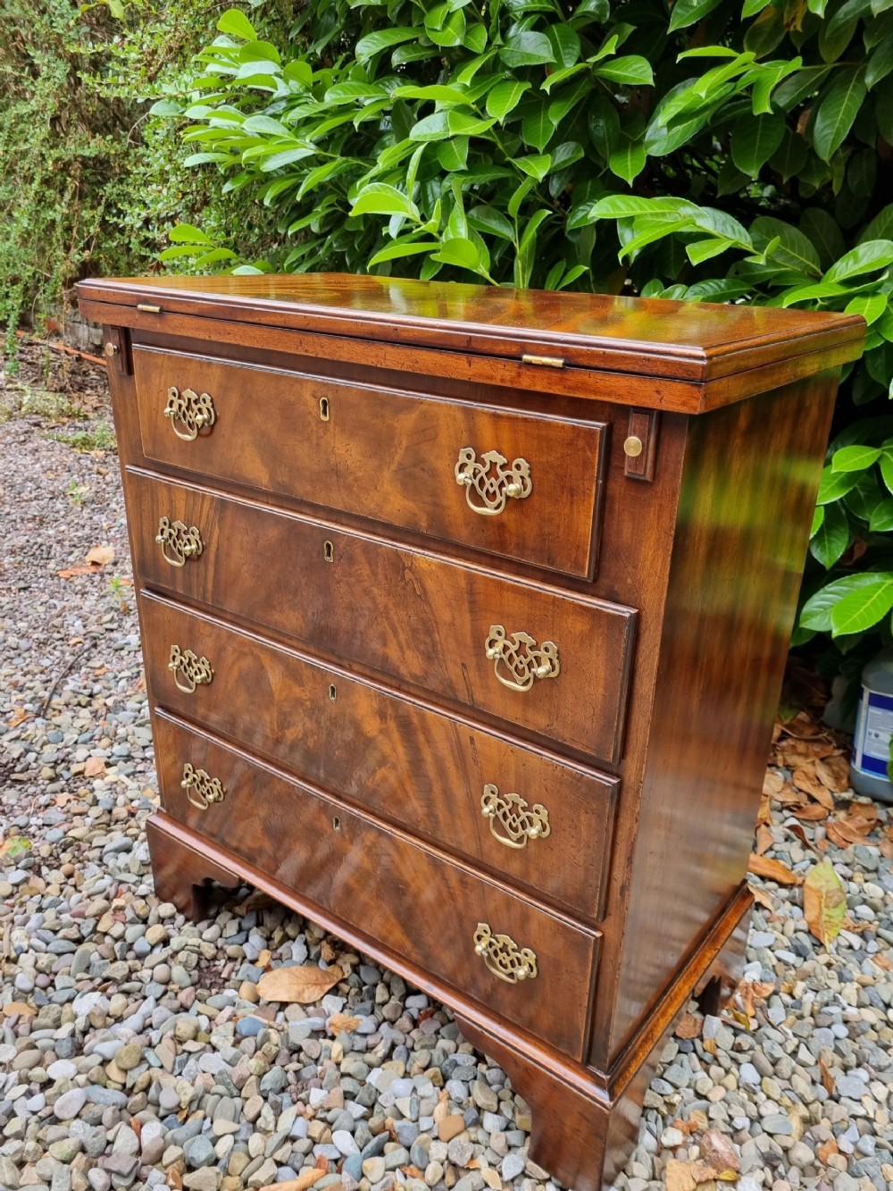 small 19c flame mahogany batchelors chest with solid folding top