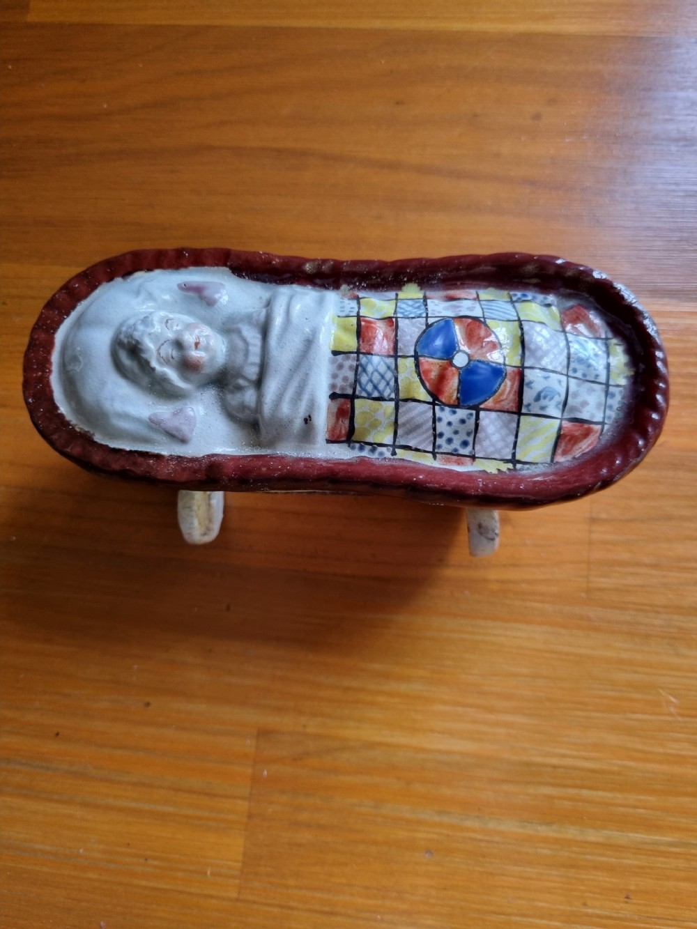 good yorkshire prattware pottery baby in a crib